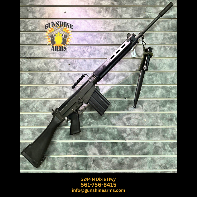 Transferable FAL machine gun, Springfield Armory SAR-48, right side on the wall with black synthetic stock and pistol grip, carry handle, box magazine, and bayonet in scabbard hanging below the barrel
